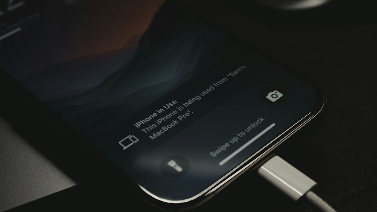 A smartphone connected to a charging cable
