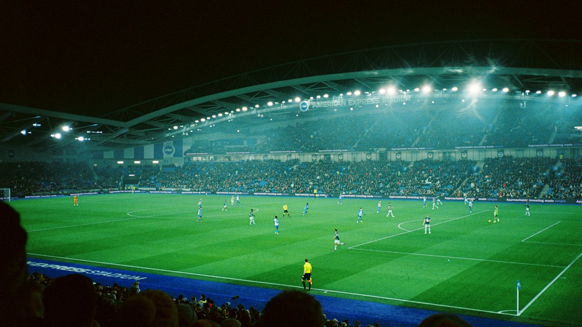 Football match at the illuminated American Express Stadium in Brighton