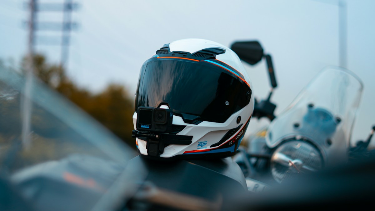 White motorcycle helmet resting on a motorcycle outdoors